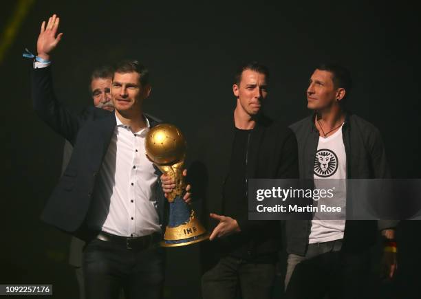 Heiner Brand, Henning Fritz, Dominik Klein and Stefan Kretzschmar bring the World Championship trophy prior to the 26th IHF Men's World Championship...