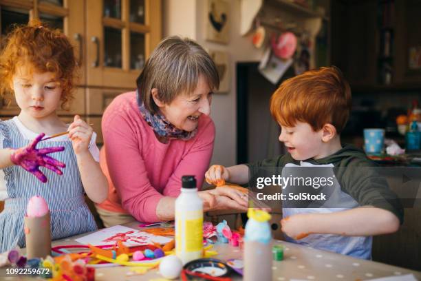 arts and crafts with grandma - 4 girls finger painting stock pictures, royalty-free photos & images