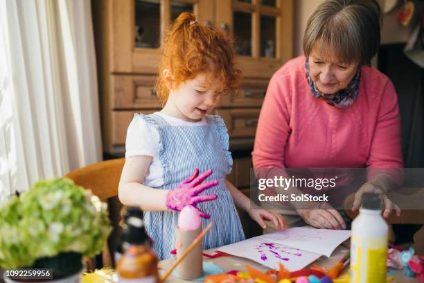 painting with grandma - 4 girls finger painting stock pictures, royalty-free photos & images