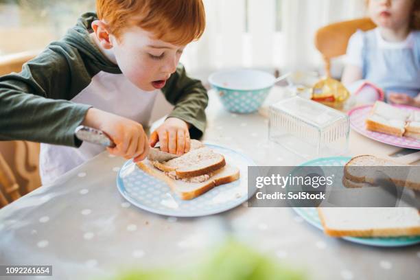 young boy making his sandwiches for lunch - making a sandwich stock pictures, royalty-free photos & images