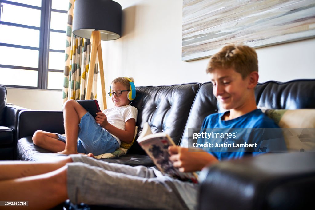 Brothers sitting on the sofa passing the time during down time