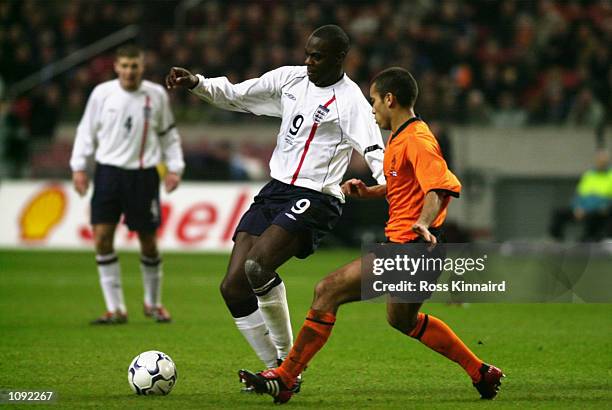 Michael Ricketts of England shields the ball from Giovanni van Bronckhorst of Holland during the International Friendly match played at the Amsterdam...