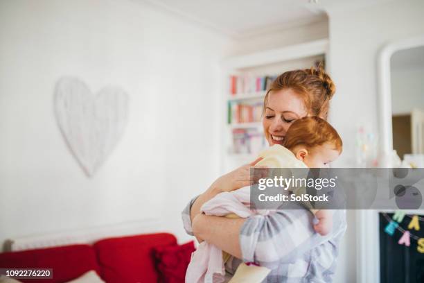 mother and her sleeping newborn - family protection stock pictures, royalty-free photos & images