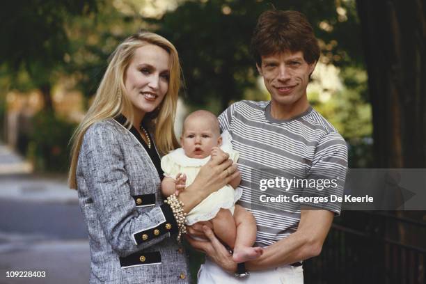 Mick Jagger and Jerry Hall with one of their children, circa 1990.