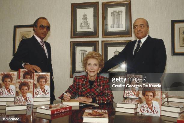 Nancy Reagan, the wife of former US President Ronald Reagan, with Egyptian businessman Mohamed Al-Fayed and his brother Sallah, 1989. Reagan is...