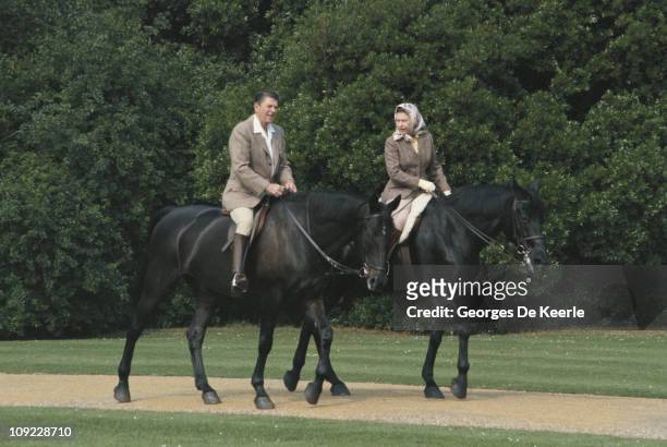 Queen Elizabeth II riding in the grounds of Windsor Castle with US President Ronald Reagan, during his state visit to the UK, 8th June 1982. She is...