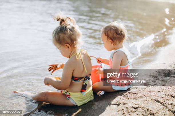 happy laughing toddler girl having fun on sand - kids pool games stock pictures, royalty-free photos & images