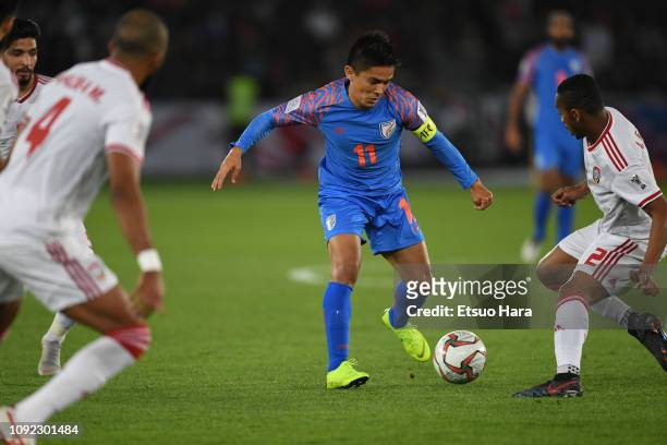 Sunil Chhetri of India controls the ball under pressure from United Arab Emirates defenders during the AFC Asian Cup Group A match between India and...