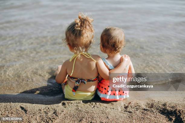 happy laughing toddler girl having fun on sand - kids pool games stock pictures, royalty-free photos & images