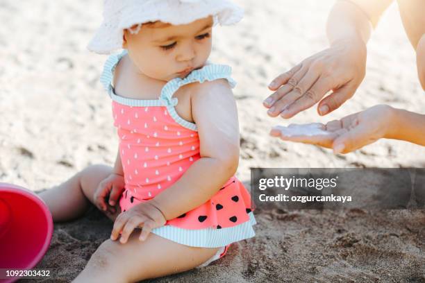 happy laughing toddler girl having fun on sand - beautiful beach babes stock pictures, royalty-free photos & images