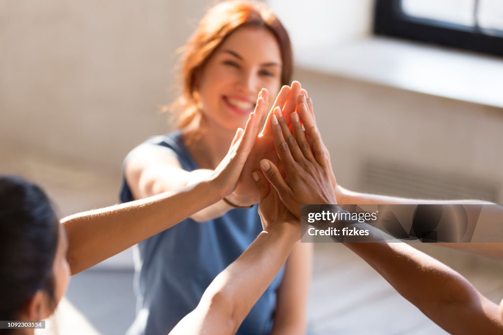 Girls giving high five, close up focus on hands
