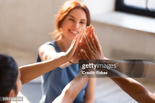 Girls giving high five, close up focus on hands Girls giving high five, close up focus on hands