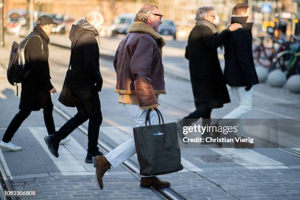 Alessandro Squarzi is seen wearing brown shearling jacket, white pants during the 95th Pitti Uomo at Fortezza Da Basso on January 10, 2019 in...