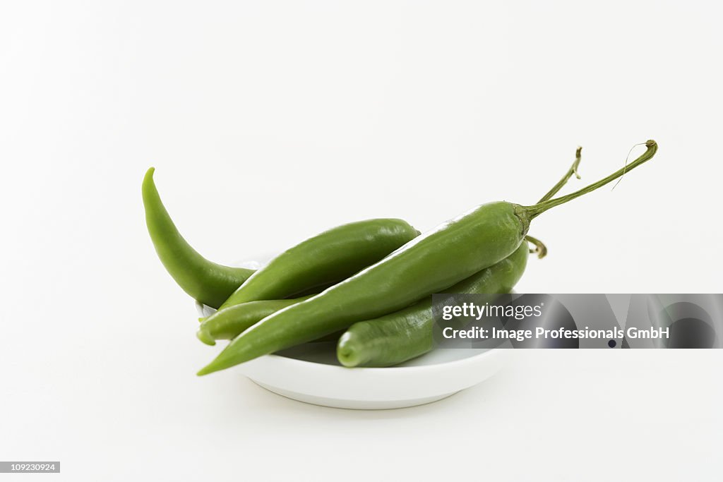 Green chillies on plate