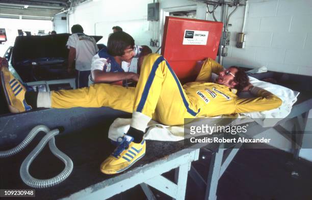 Dale Earnhardt Sr, driver of the Wrangler Ford Thunderbird, relaxes in the Daytona International Speedway garage during qualifying for the 1982...