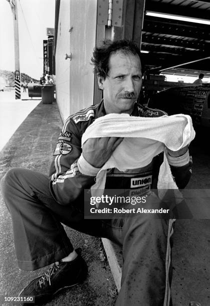 Dale Earnhardt Sr. Cools down in the Daytona International Speedway garage after completing the 1983 Firecracker 400 on July 4, 1983 in Daytona...