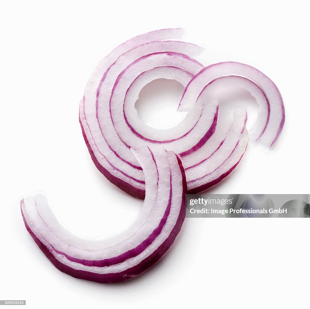 Red onion rings on white background, close-up