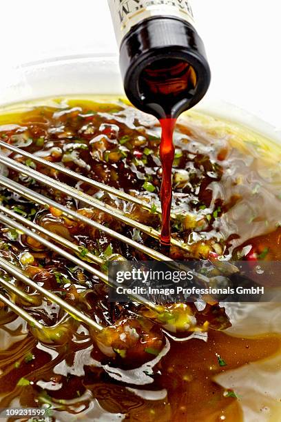 whisking salad dressing, close-up - vinaigrette dressing imagens e fotografias de stock