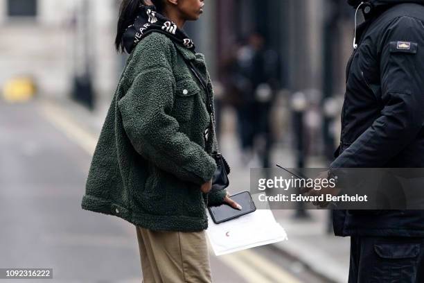 Guest wears a green fluffy jacket, during London Fashion Week Men's January 2019 on January 05, 2019 in London, England.