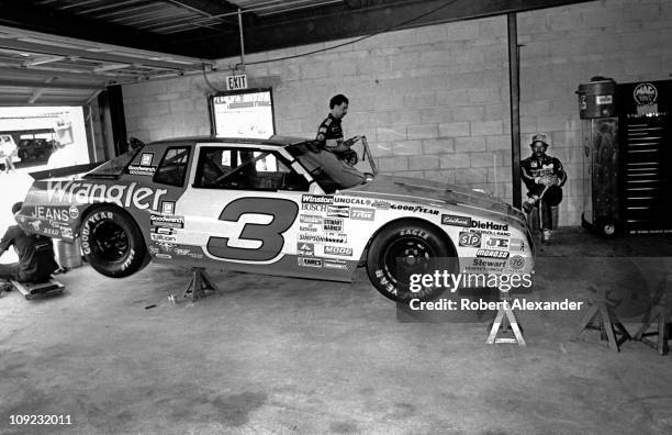 Dale Earnhardt Sr, driver of the Wrangler Chevrolet Monte Carlo, relaxes in the garage at the Daytona International Speedway prior to the start of...