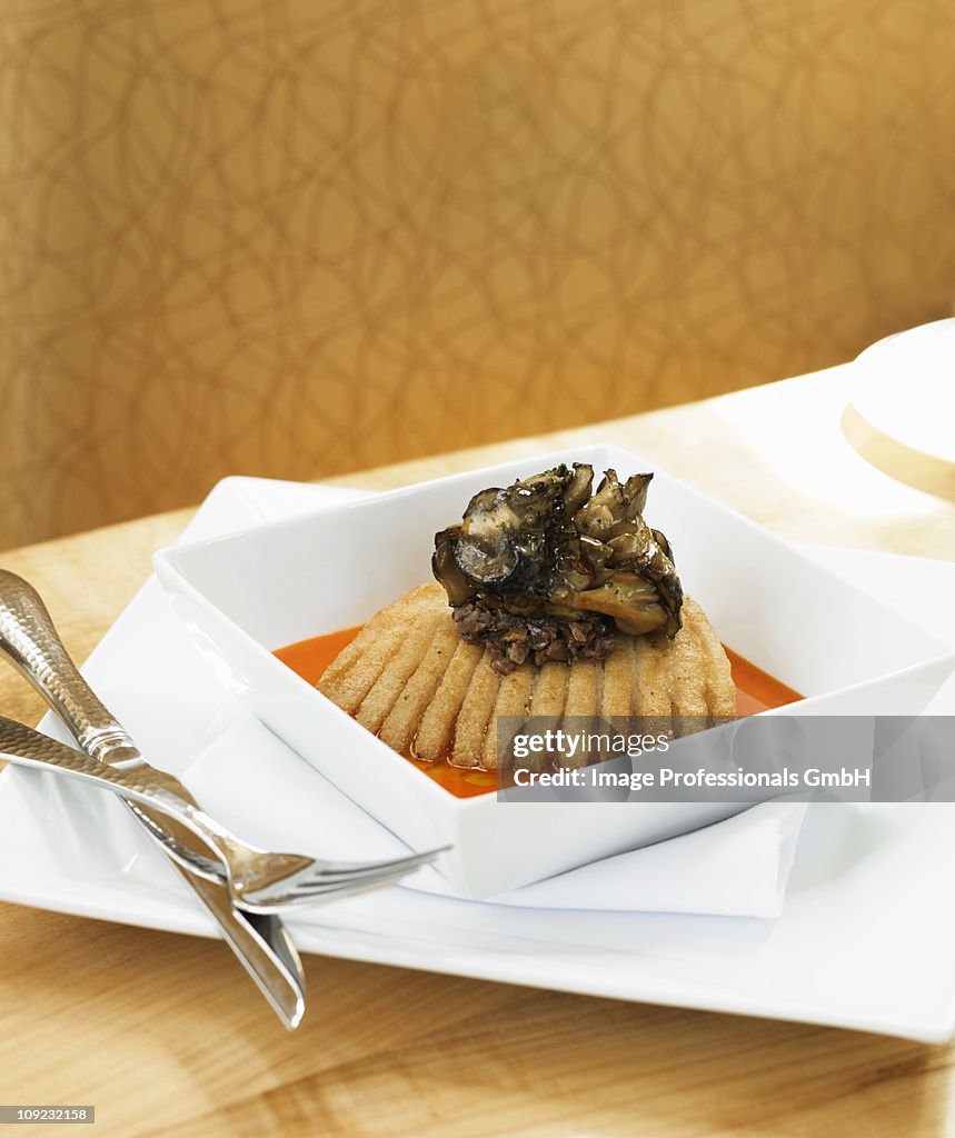 Roasted skate fish with bell pepper sauce in bowl