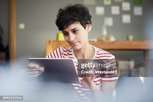 Using A Tablet Week Woman Using Tablet At Home High-Res Stock Photo - Getty Images