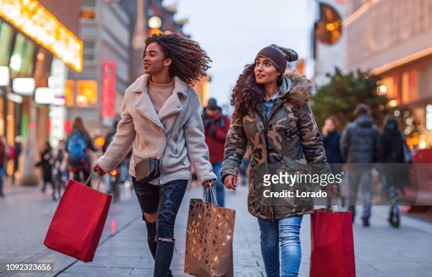 mother and daughter christmas shopping - holiday shopping stock pictures, royalty-free photos & images