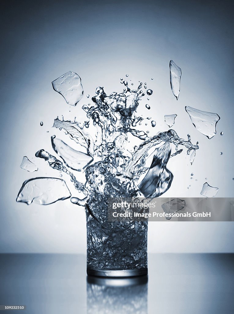 Glass of water shattering, close-up