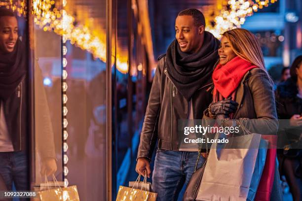 beautiful black couple at christmas shopping - amsterdam noel stock pictures, royalty-free photos & images