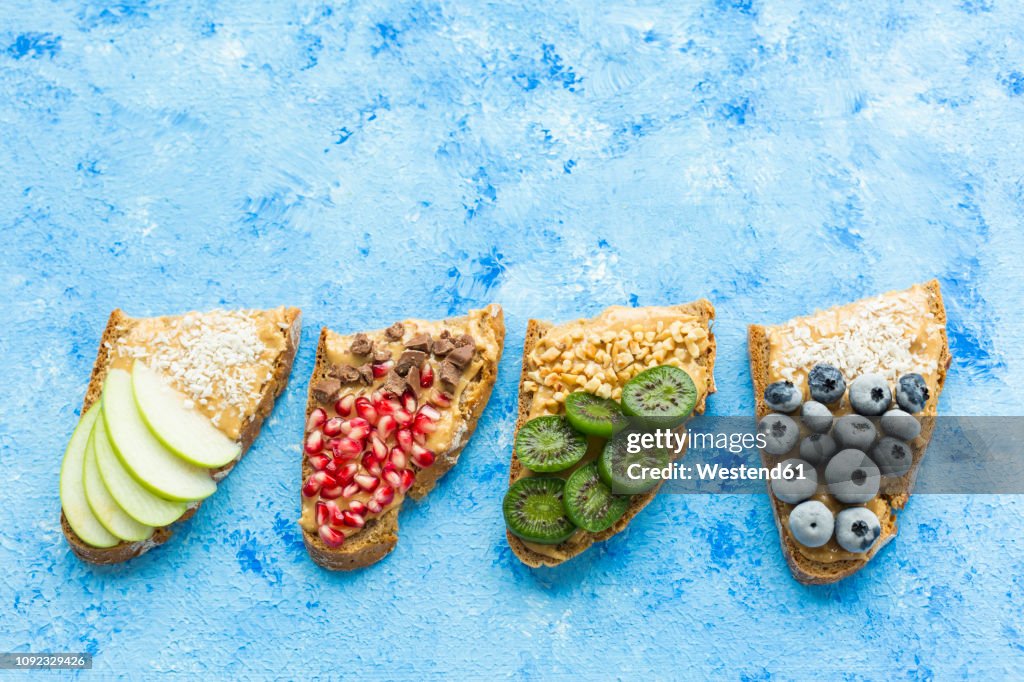 Row of bread slices with various toppings