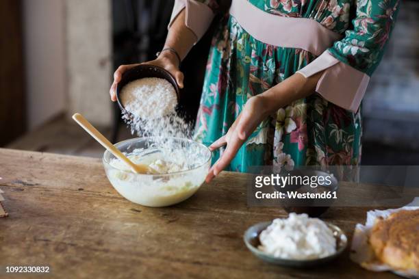young woman preparing cake dough, partial view - mixing bowl stock pictures, royalty-free photos & images