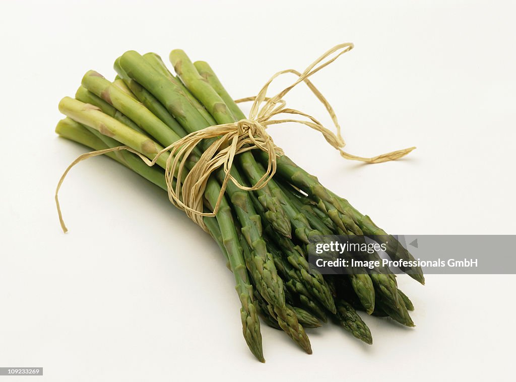 Bundle of green asparagus on white background