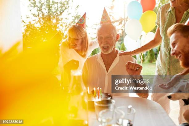 happy family on a garden birthday party - surprise birthday party stock pictures, royalty-free photos & images