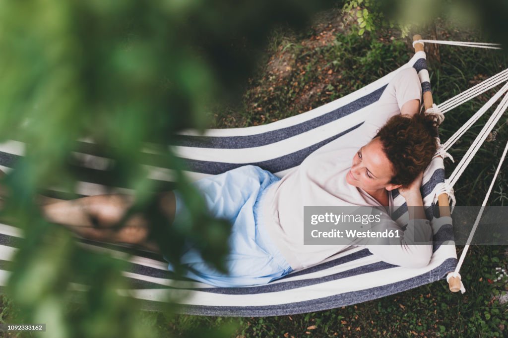 Woman lying in a hammock