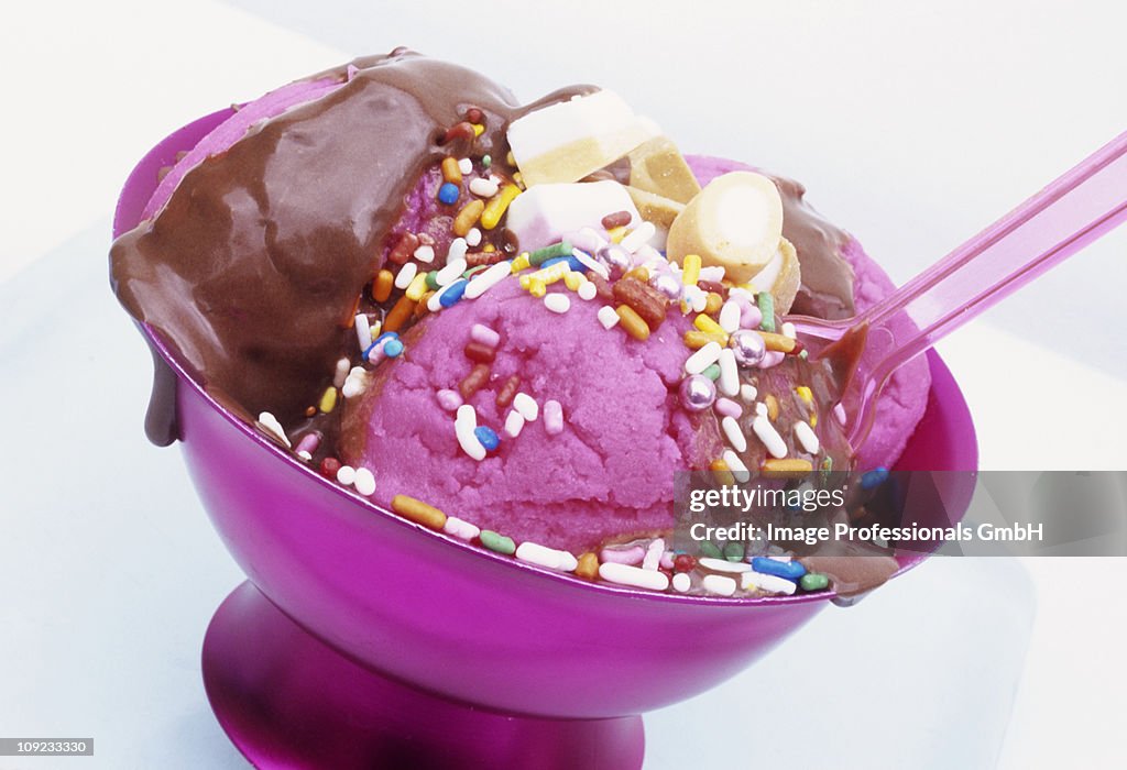 Pink ice cream with chocolate sauce, close-up