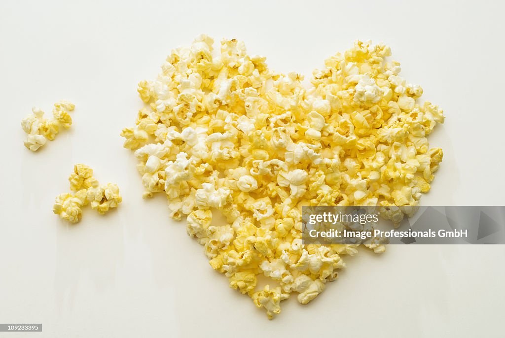 Popcorn heart on white background, close-up