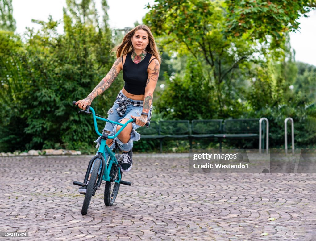 Young woman riding her BMX bike