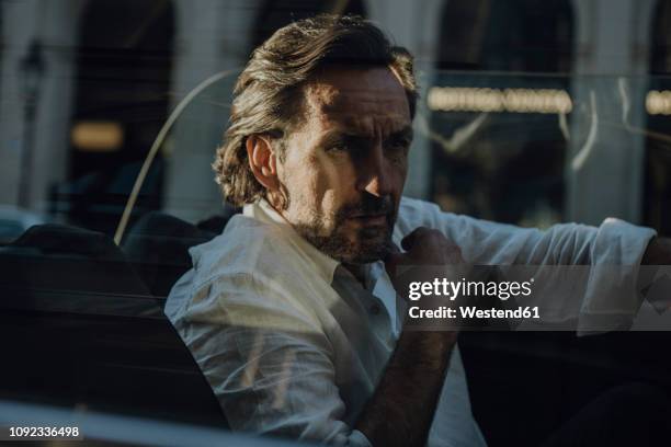 man driving convertible in munich, bavaria, germany - car reflection stock-fotos und bilder