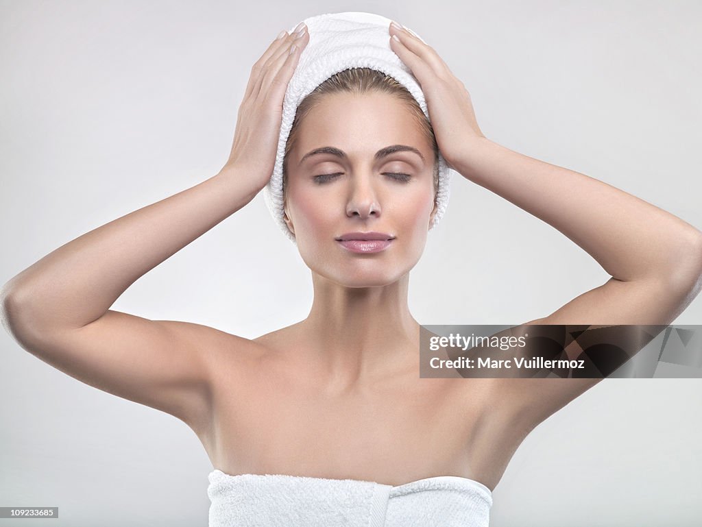 Young woman wrapped in towels