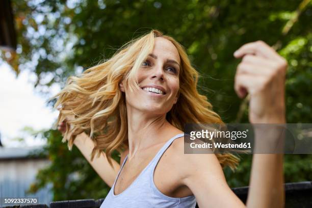 carefree blond woman outdoors - beautiful people stock-fotos und bilder