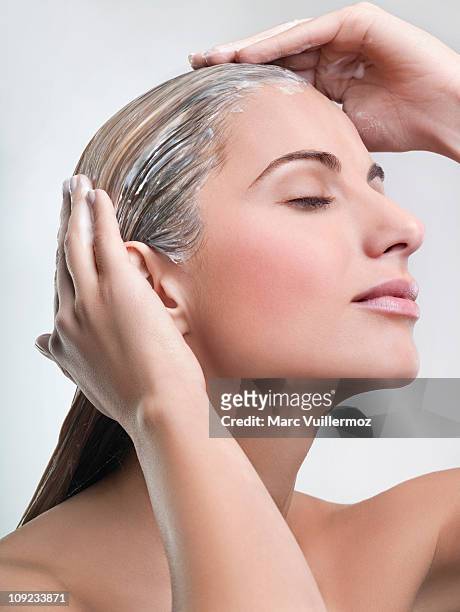 young woman applying hair mask - body care and beauty stock pictures, royalty-free photos & images