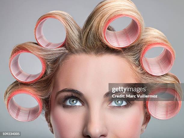 young woman in curlers - hair curlers stockfoto's en -beelden