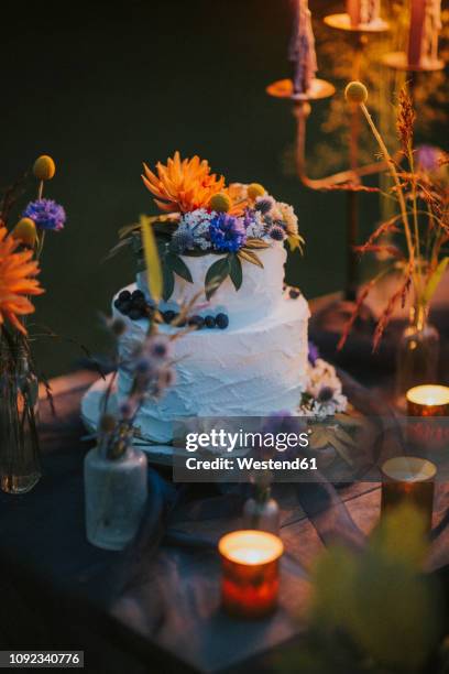 wedding cake on table with candles outdoors - table romantique photos et images de collection