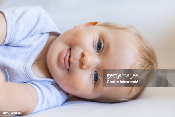 portrait of blond baby girl lying on couch - one baby girl only stock pictures, royalty-free photos & images