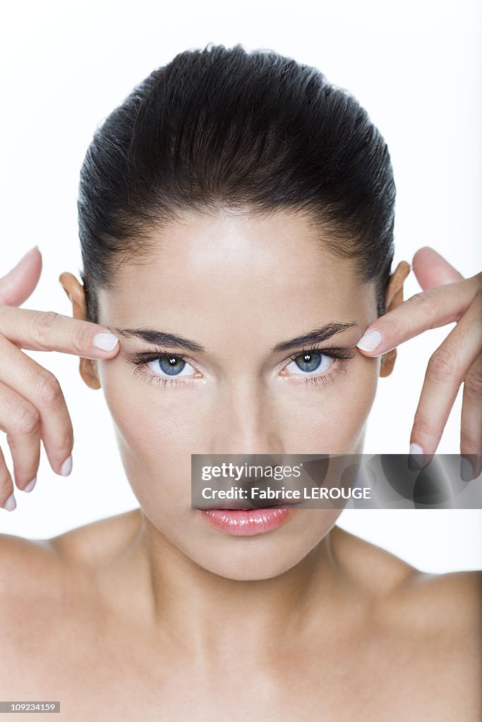 Young woman with fingers on temples