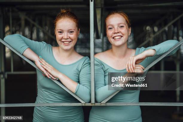 laughing redheaded twins - twin stock-fotos und bilder