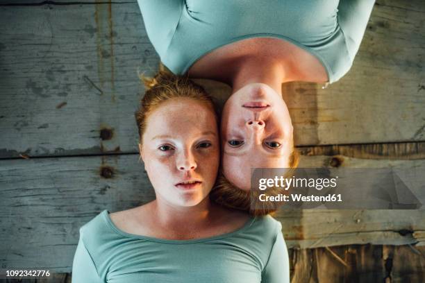 redheaded twins lying on ground, looking at camera - identical twin stock pictures, royalty-free photos & images