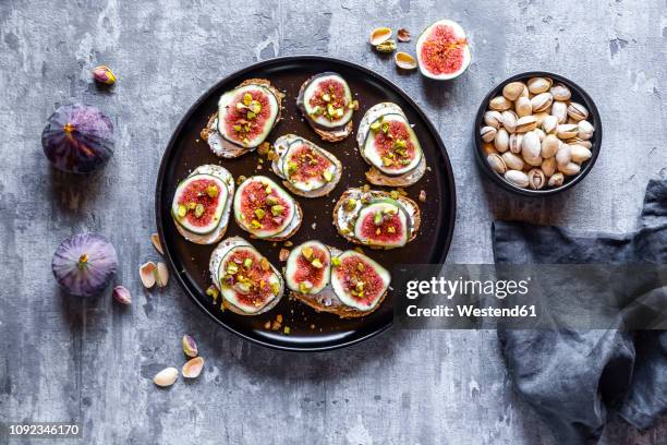 bread with goat cheese, figs and pistachio - tea towels stock pictures, royalty-free photos & images