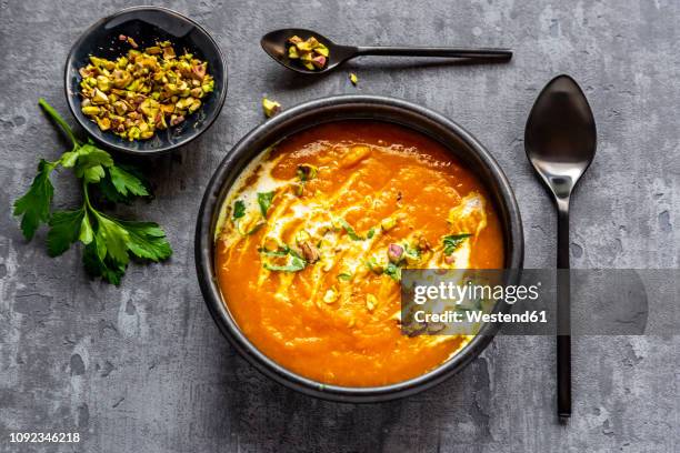 sweet potato soup with curcuma, coriander and pistazio - sweet potato stock-fotos und bilder