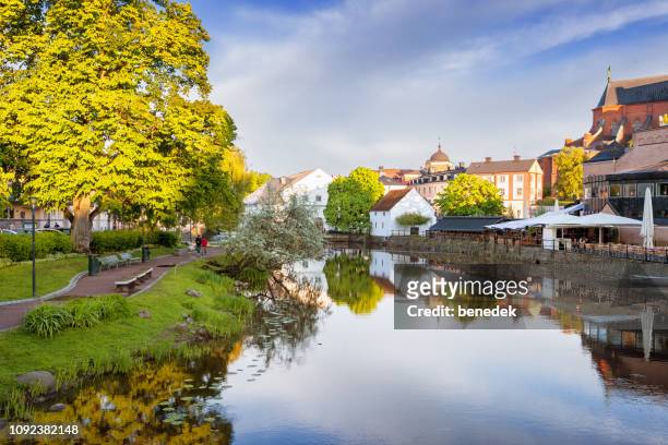 park and restaurant along the fyris river in downtown uppsala sweden - uppsala stock pictures, royalty-free photos & images